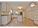 A kitchen featuring white cabinetry, green countertops, a kitchen island and tile floors at 212 Garret Rdg, Peachtree City, GA 30269