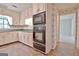 A kitchen featuring white cabinetry, green countertops, and stainless-steel appliances at 212 Garret Rdg, Peachtree City, GA 30269