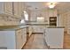 A kitchen featuring white cabinetry, green countertops, a kitchen island and tile floors at 212 Garret Rdg, Peachtree City, GA 30269