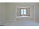 Bright, empty living room with neutral carpet and large windows at 212 Garret Rdg, Peachtree City, GA 30269