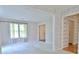 Open living room featuring plush carpeting, neutral walls, and natural light with seamless access to the front entry at 212 Garret Rdg, Peachtree City, GA 30269