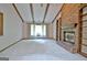 Bright living room with beamed ceiling, brick fireplace, and built-in bookshelves at 212 Garret Rdg, Peachtree City, GA 30269