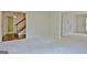 Open-concept living room featuring neutral carpeting, large windows, and natural light at 212 Garret Rdg, Peachtree City, GA 30269