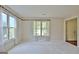 Bright living room featuring carpeted floors, neutral walls, and large windows with sheer curtains allowing ample natural light at 212 Garret Rdg, Peachtree City, GA 30269