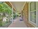 Covered brick porch featuring white columns and green landscaping at 212 Garret Rdg, Peachtree City, GA 30269