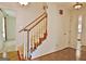 Foyer staircase with carpeted steps, wooden banister, and patterned wallpaper at 212 Garret Rdg, Peachtree City, GA 30269