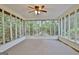 Enclosed sunroom with ceiling fan and views of the surrounding foliage at 212 Garret Rdg, Peachtree City, GA 30269