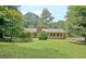 Green backyard and exterior of the home with a combination of brick and siding at 501 Bridlepath Ln, Peachtree City, GA 30269