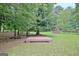 A wooden platform with shed in a tree-lined backyard at 501 Bridlepath Ln, Peachtree City, GA 30269
