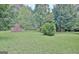 Well-maintained backyard with mature trees and a storage shed at 501 Bridlepath Ln, Peachtree City, GA 30269