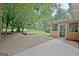 Backyard with a patio, raised wooden platform and screened in porch at 501 Bridlepath Ln, Peachtree City, GA 30269