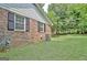 Brick house exterior with a well-kept lawn, an AC unit, and mature trees providing shade at 501 Bridlepath Ln, Peachtree City, GA 30269
