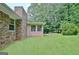 Side view of home overlooking a lush backyard and trees at 501 Bridlepath Ln, Peachtree City, GA 30269
