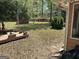 Scenic backyard features mature trees, a small storage shed, and an American flag at 501 Bridlepath Ln, Peachtree City, GA 30269
