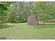 Exterior of a backyard barn, offering ample storage space and a charming rustic appeal at 501 Bridlepath Ln, Peachtree City, GA 30269