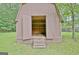 Backyard barn exterior showcasing open doors, steps, and shelving for storage solutions at 501 Bridlepath Ln, Peachtree City, GA 30269