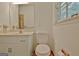 Bathroom featuring a toilet, sink and mirror at 501 Bridlepath Ln, Peachtree City, GA 30269