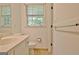 White bathroom features a toilet, vanity and sink at 501 Bridlepath Ln, Peachtree City, GA 30269