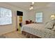 Bedroom features natural light, wood floors, fan, and closet at 501 Bridlepath Ln, Peachtree City, GA 30269