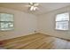 Bedroom featuring two windows and wood-look floors at 501 Bridlepath Ln, Peachtree City, GA 30269
