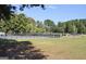 Community pool is fenced for safety with a playground nearby in a park-like setting at 501 Bridlepath Ln, Peachtree City, GA 30269