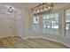 Bright dining nook features vinyl floors, modern lighting, and large bay windows with backyard view at 501 Bridlepath Ln, Peachtree City, GA 30269