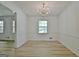 Charming dining room with a stylish chandelier, wainscoting, and bright natural light at 501 Bridlepath Ln, Peachtree City, GA 30269