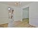 Bright dining room with modern flooring, classic chandelier, and easy access to the kitchen at 501 Bridlepath Ln, Peachtree City, GA 30269