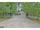 Wide concrete driveway leads to a detached garage with a white picket fence at 501 Bridlepath Ln, Peachtree City, GA 30269