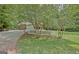 Home exterior showcasing a white picket fence and long driveway to garage at 501 Bridlepath Ln, Peachtree City, GA 30269