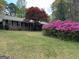 Charming single-story home with a well-manicured lawn and beautiful landscaping at 501 Bridlepath Ln, Peachtree City, GA 30269