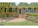 Charming brick home facade with symmetrical windows and manicured landscaping at 501 Bridlepath Ln, Peachtree City, GA 30269