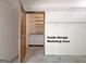 Well-organized workshop area in the garage includes shelving and cabinetry for storage at 501 Bridlepath Ln, Peachtree City, GA 30269