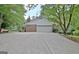 Detached two-car garage with white door and spacious concrete driveway at 501 Bridlepath Ln, Peachtree City, GA 30269