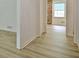 Hallway with laminate flooring showing a glimpse of a brick wall and window at 501 Bridlepath Ln, Peachtree City, GA 30269