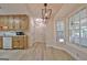 Renovated kitchen with white appliances and a view to the breakfast nook, featuring a large bay window at 501 Bridlepath Ln, Peachtree City, GA 30269