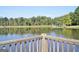 Relaxing lake view from the wood fence with a covered gazebo visible on the opposite side at 501 Bridlepath Ln, Peachtree City, GA 30269