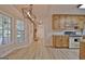 Open concept kitchen/living room featuring an accent fireplace, lots of light and vinyl floors at 501 Bridlepath Ln, Peachtree City, GA 30269