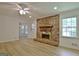 Bright living room features a brick fireplace, new floors, and access to the sunroom at 501 Bridlepath Ln, Peachtree City, GA 30269