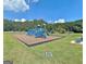 Community playground with slides, climbing structures, and a safety surface for children at 501 Bridlepath Ln, Peachtree City, GA 30269