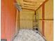 Inside view of shed with wood walls, open ceiling framing and wire rack shelving at 501 Bridlepath Ln, Peachtree City, GA 30269