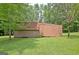 Side view of a brown shed on green lawn surrounded by trees at 501 Bridlepath Ln, Peachtree City, GA 30269