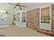 Spacious sunroom with brick wall and several windows providing natural light and backyard views at 501 Bridlepath Ln, Peachtree City, GA 30269