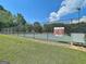 View of the fenced community tennis court, ready for a match at 501 Bridlepath Ln, Peachtree City, GA 30269