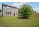 Backyard with new fence, green grass, patio, and mature tree at 2493 Oakleaf Rdg, Lithonia, GA 30058
