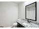 Compact bathroom featuring a single vanity with granite countertop and simple mirror at 2493 Oakleaf Rdg, Lithonia, GA 30058