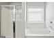 Bright bathroom with separate shower and soaking tub under a window at 2493 Oakleaf Rdg, Lithonia, GA 30058