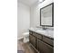 Small bathroom with vinyl floors, single vanity with a granite counter and dark cabinets at 2493 Oakleaf Rdg, Lithonia, GA 30058