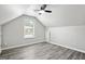 Bright bedroom with neutral paint, wood-look floors, window, and ceiling fan at 2493 Oakleaf Rdg, Lithonia, GA 30058