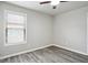 Empty room with gray laminate flooring and window at 2493 Oakleaf Rdg, Lithonia, GA 30058